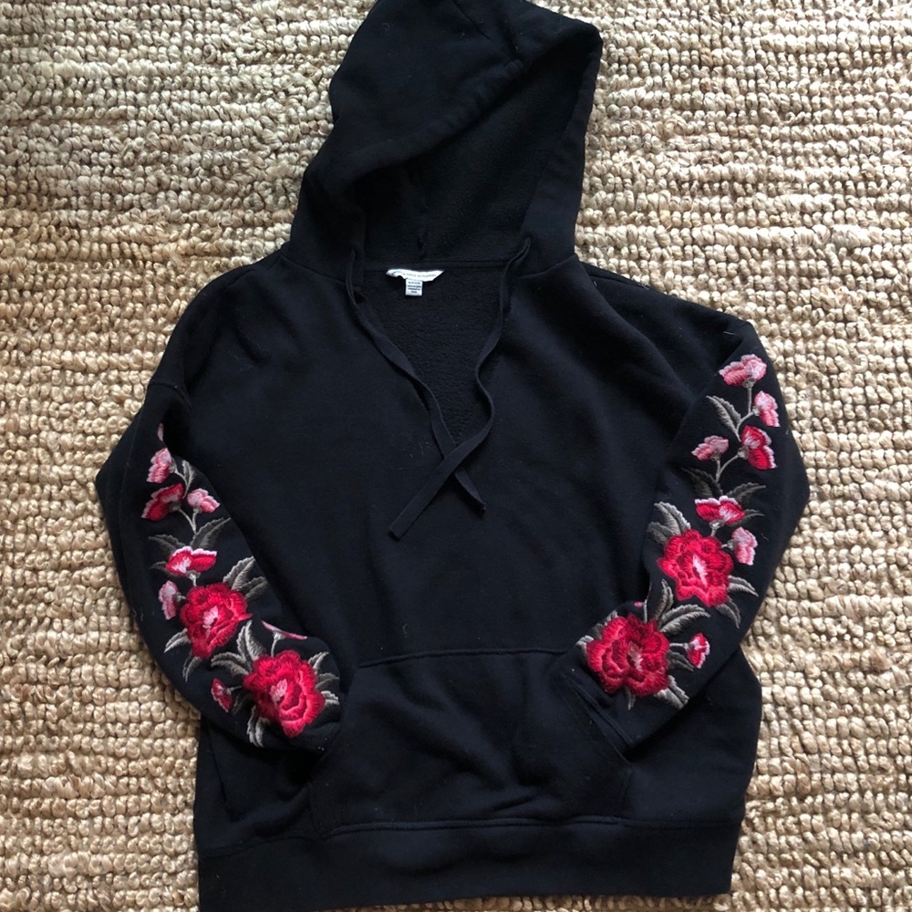 Black sweatshirt with flower detail on sleeves
